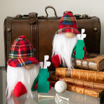 Load image into Gallery viewer, Two gnome figurines with plaid hats and golf accessories in front of a vintage suitcase and books.
