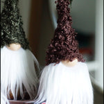 Load image into Gallery viewer, Two decorative gnomes with brown hats and white beards on a wooden surface.
