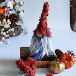Load image into Gallery viewer, Gnome with red hair and gray beard surrounded by pumpkins and decorative items on a white surface.
