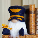 Load image into Gallery viewer, Gnome with a blue hat and white beard holding a gold key, standing next to two old books.
