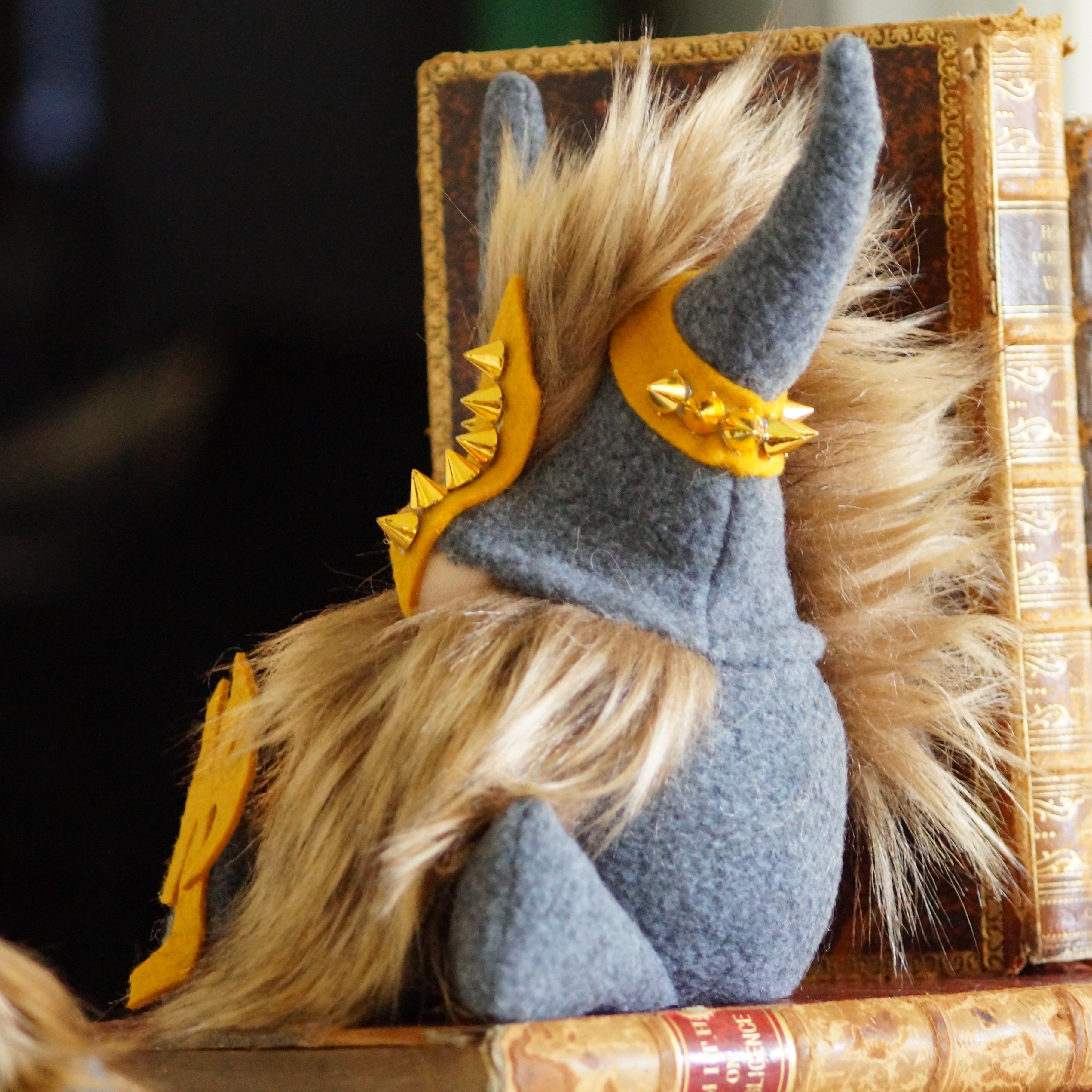 Stuffed animal with Viking helmet sitting on a stack of books