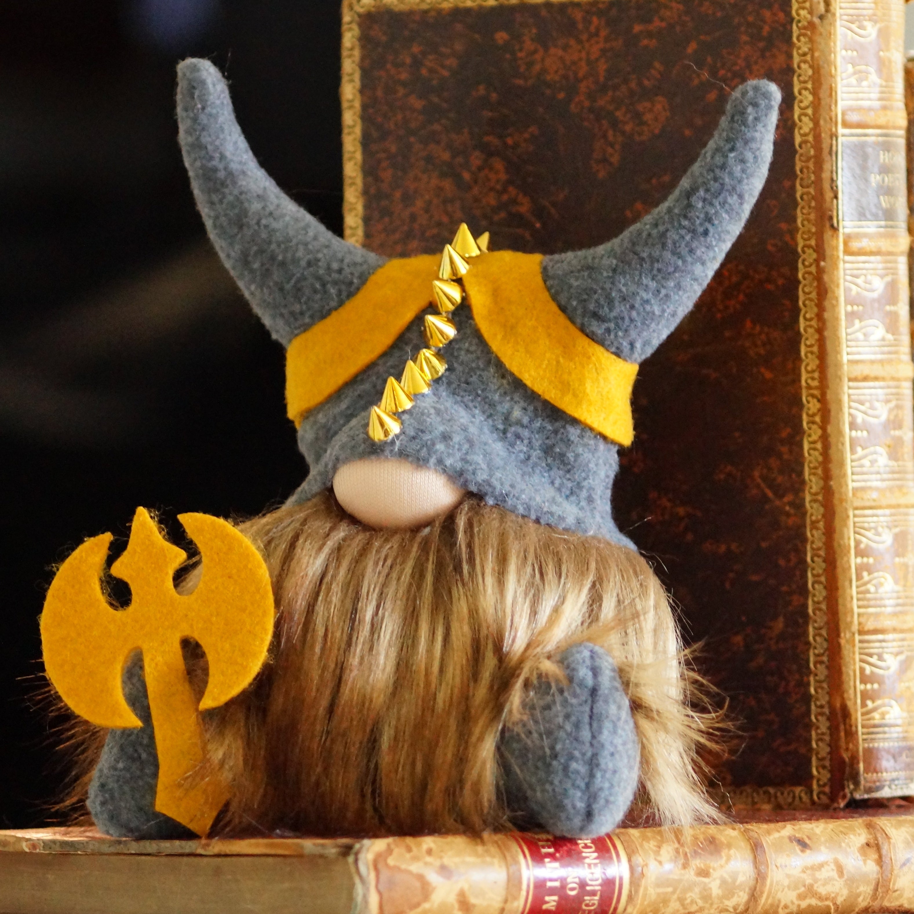 Gnome figurine with Viking helmet on top of books