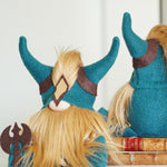 Load image into Gallery viewer, Two plush toys with blue helmets and blonde hair on top of books.
