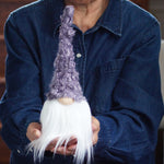 Load image into Gallery viewer, Person holding a white gnome with a purple hat indoors
