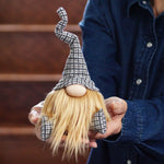 Load image into Gallery viewer, Person holding a small gnome figurine with a checkered hat and blonde hair.
