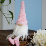 Load image into Gallery viewer, Gnome with a pink hat on a wooden base with flowers in the background

