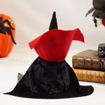 Load image into Gallery viewer, Back view of a Halloween-themed Dracula gnome with black velvet hat and cape with red collar, sitting on a white surface with books and a skull in the background ideal for cute Scandinavian Halloween decor
