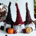 Load image into Gallery viewer, Three decorative gnomes with autumn-themed accessories on a table.
