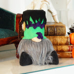 Load image into Gallery viewer, Halloween-themed gnome with green head and purple accents on a table with pumpkins and books.
