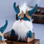 Load image into Gallery viewer, Gimli the Viking, a handmade focus guardian with teal horns and a mask, sits atop vintage books and boosts productivity.
