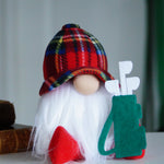 Load image into Gallery viewer, Close-up of a handmade golfer gnome with a plaid hat and a small green golf bag accessory.
