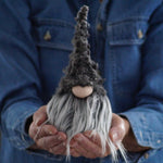 Load image into Gallery viewer, Person holding a small grey gnome with a blue shirt
