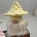 Load image into Gallery viewer, Handmade gnome with a yellow mushroom hat and white beard sitting on a stack of books on a white table. 
