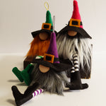 Load image into Gallery viewer, A set of three colourful witch ornaments with green, pink and purple hats, black outfits, and various coloured beards, designed for Halloween decoration.
