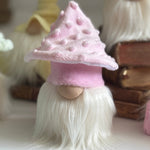 Load image into Gallery viewer, Small handmade gnome with a pink textured mushroom hat and white beard sitting on a white table. 
