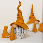 Load image into Gallery viewer, Two handmade gnome dolls with orange hats sit on a white surface, perfect as whimsical home office or library guardians.
