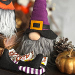 Load image into Gallery viewer, Halloween-themed gnome with purple hat and candy, surrounded by pumpkins and decorations. Ideal for cute Scandinavian Halloween decor
