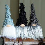 Load image into Gallery viewer, Three decorative gnomes with different colored hats on a suitcase.
