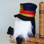 Load image into Gallery viewer, Police officer Gnome with a navy hat and white beard sitting on vintage books against a light background
