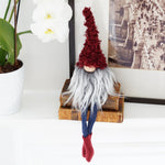 Load image into Gallery viewer, Gnome figurine with red hair and beard on a wooden block with a plant and framed picture in the background.
