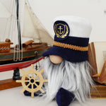 Load image into Gallery viewer, Seaside captain gnome with maritime details styled on a tiered tray next to sailboat and books for lake house summer decor.
