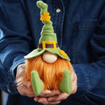 Load image into Gallery viewer, Person holding The Irish St Patrick's day gnome other wise know and the Irish Lad, a handmade leprechaun gnome with a structured green hat and a bright ginger beard and gold shamrock on the hat
