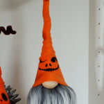 Load image into Gallery viewer, Two Halloween-themed gnomes with orange hats and gray beards on a shelf with pumpkins and decorative items.
