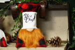 Load image into Gallery viewer, A decorative gnome figurine with a red and black buffalo plaid hat, a white face panel reading 'Yes Chef!' in black script, and a long orange beard, displayed on a shelf with pinecones and greenery.

