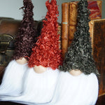 Load image into Gallery viewer, Three gnome figurines with different colored hats on a wooden surface.
