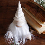 Load image into Gallery viewer, White gnome figurine with a hat on an open book
