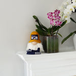 Load image into Gallery viewer, Decorative gnome, potted orchids, and a white wall in a home setting
