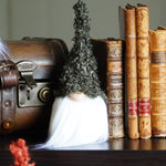 Load image into Gallery viewer, Green fall gnome sitting next toVintage suitcase, books, and decorative items on a table
