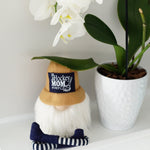 Load image into Gallery viewer, White flowers with a potted plant and a pair of socks on a white surface

