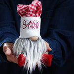 Load image into Gallery viewer, Person holding a gnome with thats Amore text against a dark background
