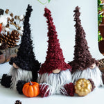 Load image into Gallery viewer, Three decorative gnomes with autumn-themed accessories on a table.
