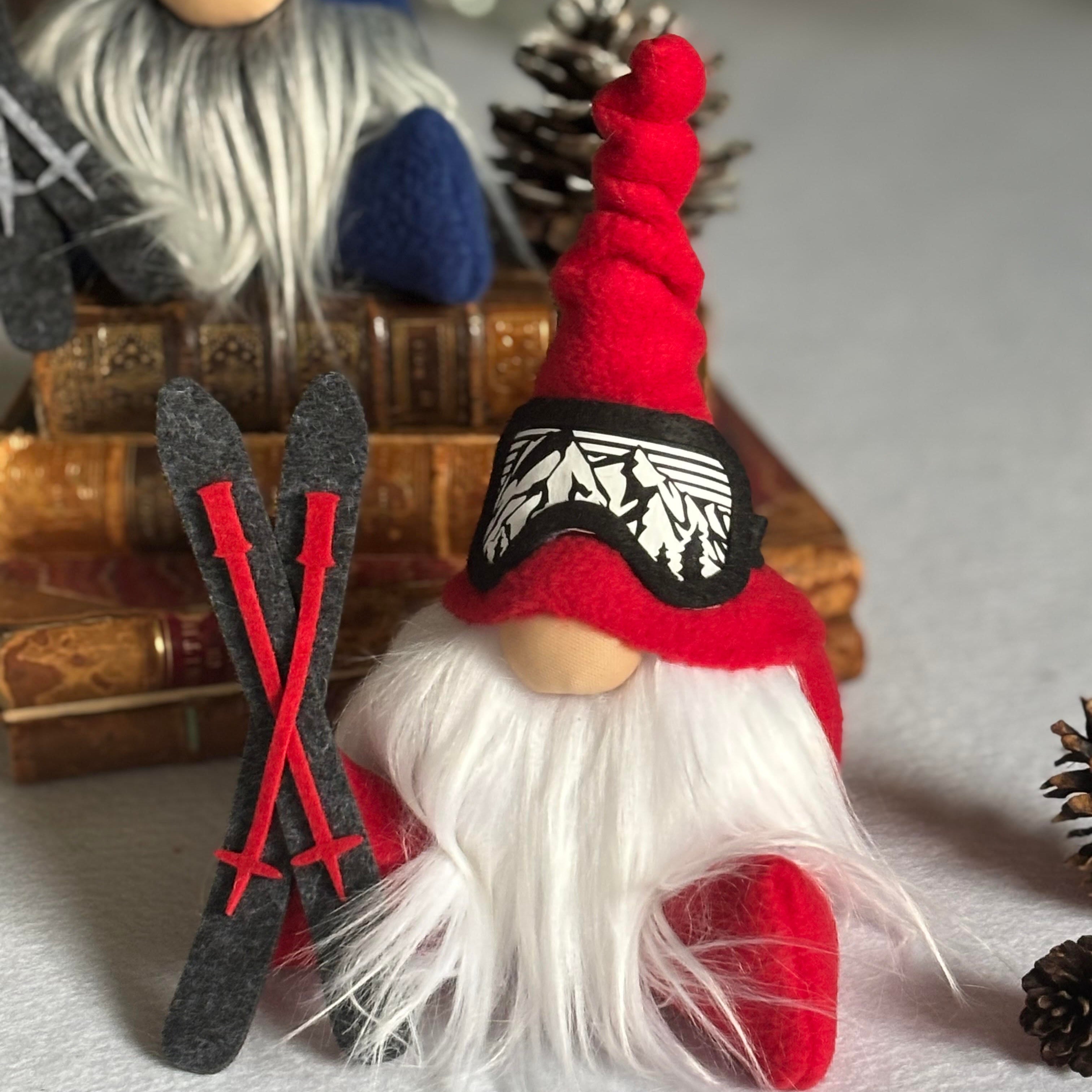 Two decorative ski gnomes with red and blue hats ski goggles and  a set of skis
