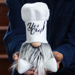 Load image into Gallery viewer, Gnome with a chef hat labeled 'Yes Chef' held by a person wearing a dark blue jacket.
