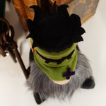 Load image into Gallery viewer, A handmade gnome with a green head resembling Frankenstein's monster. The gnome has a gray beard and is seated against a decorative antique books and keys. Ideal for cute Halloween tiered tray decor

