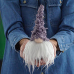 Load image into Gallery viewer, Person holding a small Scandinavian lilac gnome with a purple hat and white beard.
