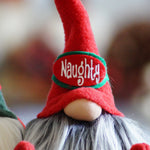 Load image into Gallery viewer, A handmade holiday guardian gnome with a long white beard sports a red “Naughty” hat, perfect for fans of Naughty gnome otherwise called Nancy.
