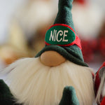Load image into Gallery viewer, Stuffed Christmas gnome doll, one of our handmade holiday guardians, with a long white beard and a green hat labeled NICE on a red band.
