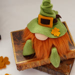 Load image into Gallery viewer, Close up of The Irish Lad, a handmade leprechaun gnome with a bendable green hat and a bright ginger beard, sitting on a stack of books.
